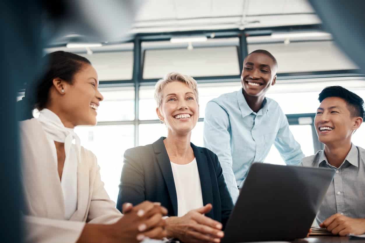 A group of people laughing in a meeting