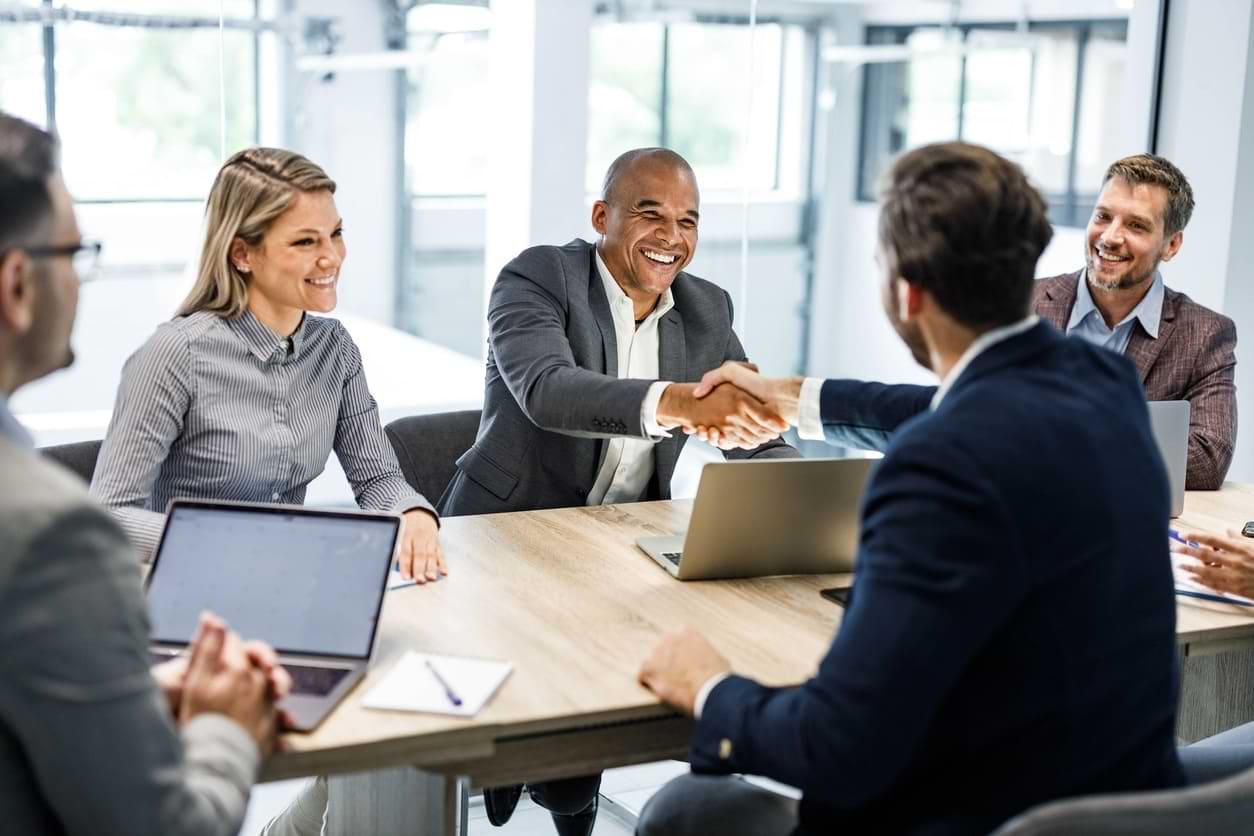 Man shaking hands with another man during a meeting