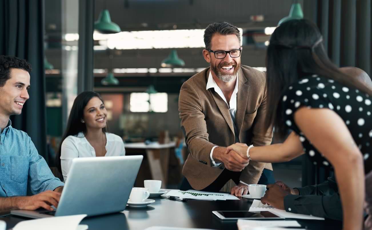 Man shaking hands with another man during a meeting