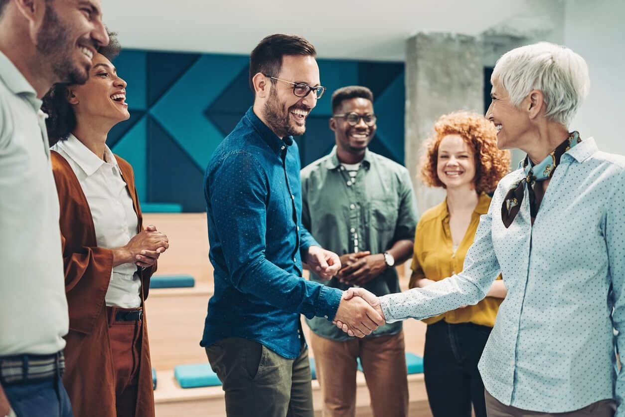 A Group of Professionals Shaking Hands at the Office at PEO Canada