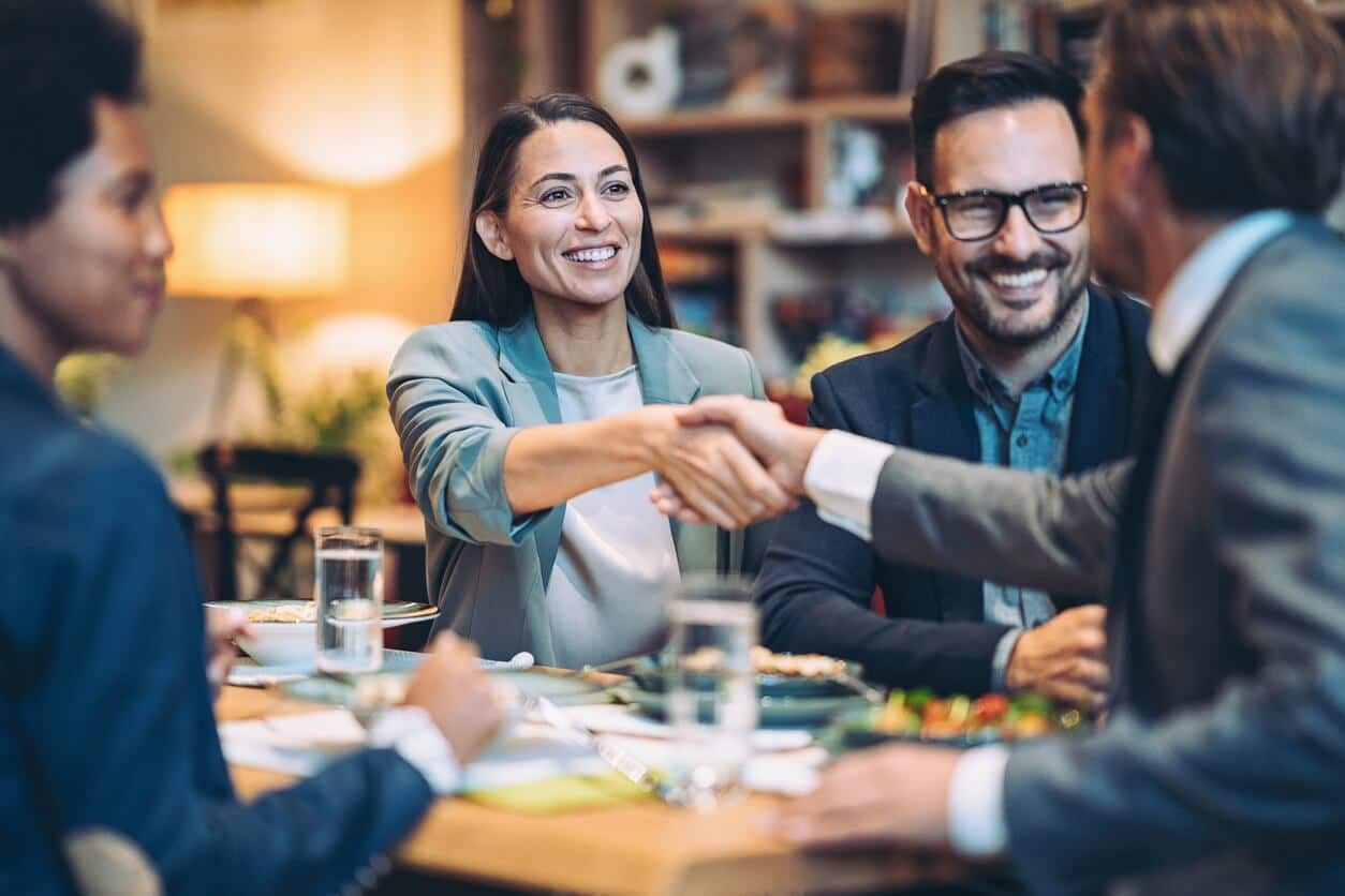 Business professionals engaging in a handshake during a formal meeting