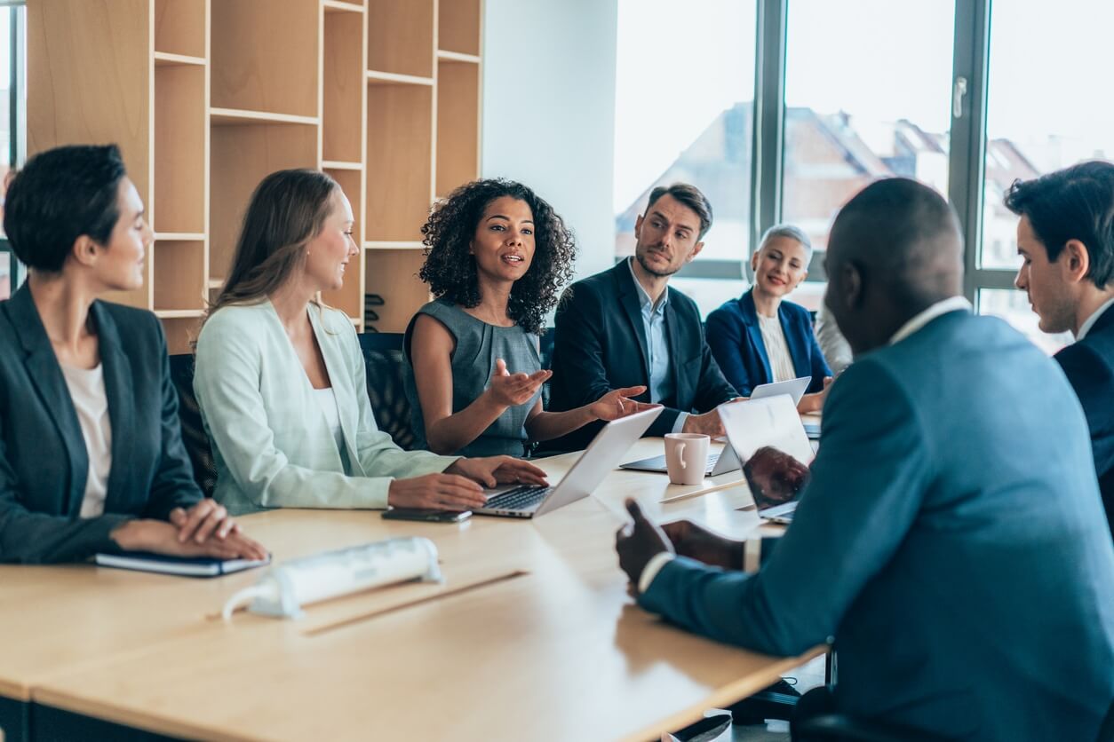 Business individuals collaborating and sharing ideas at a conference table