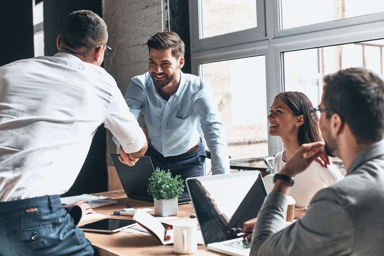 Man Shaking Hands With Another Man During a Meeting