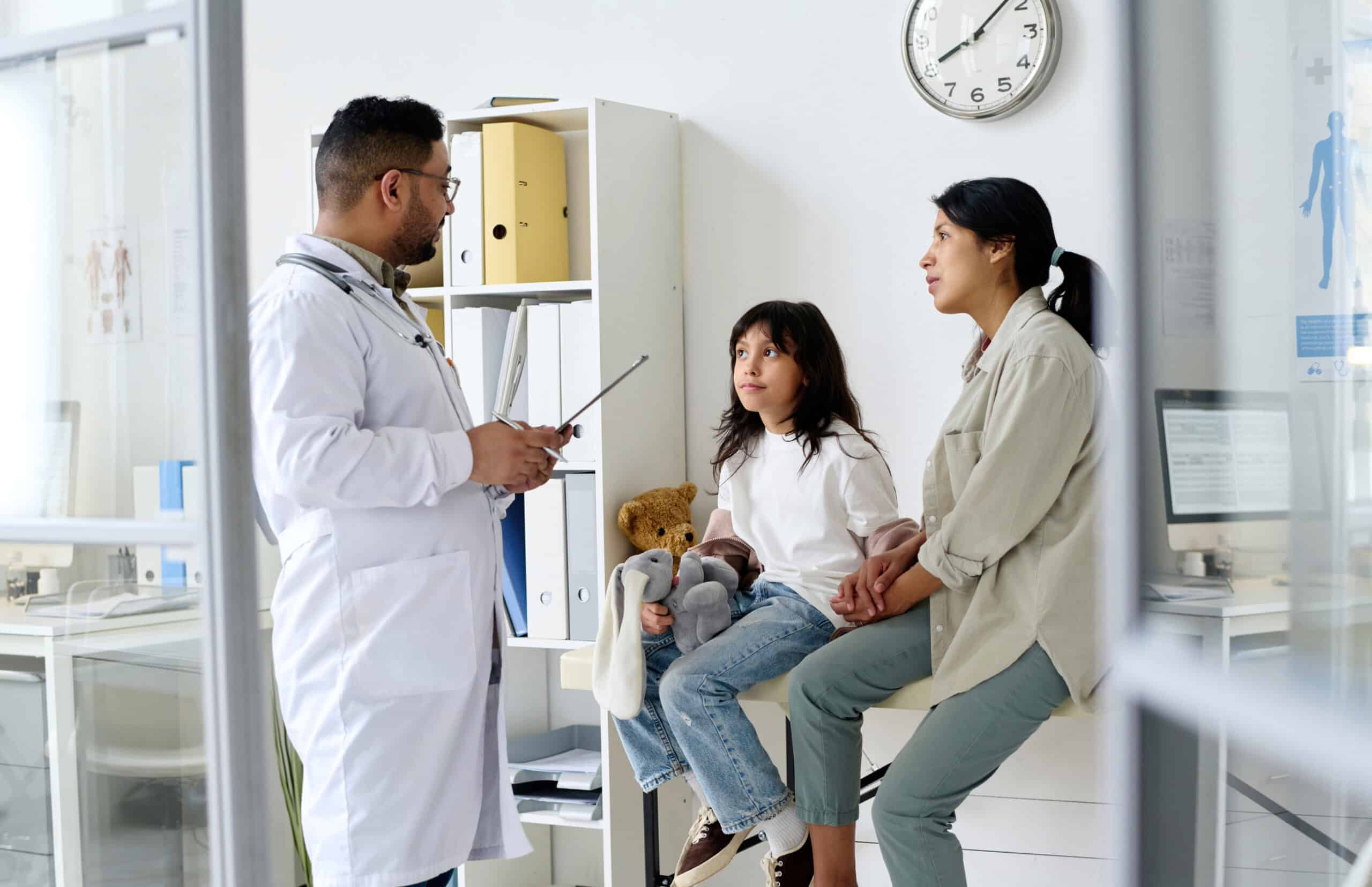 A doctor diagnosing a child who came with her mother