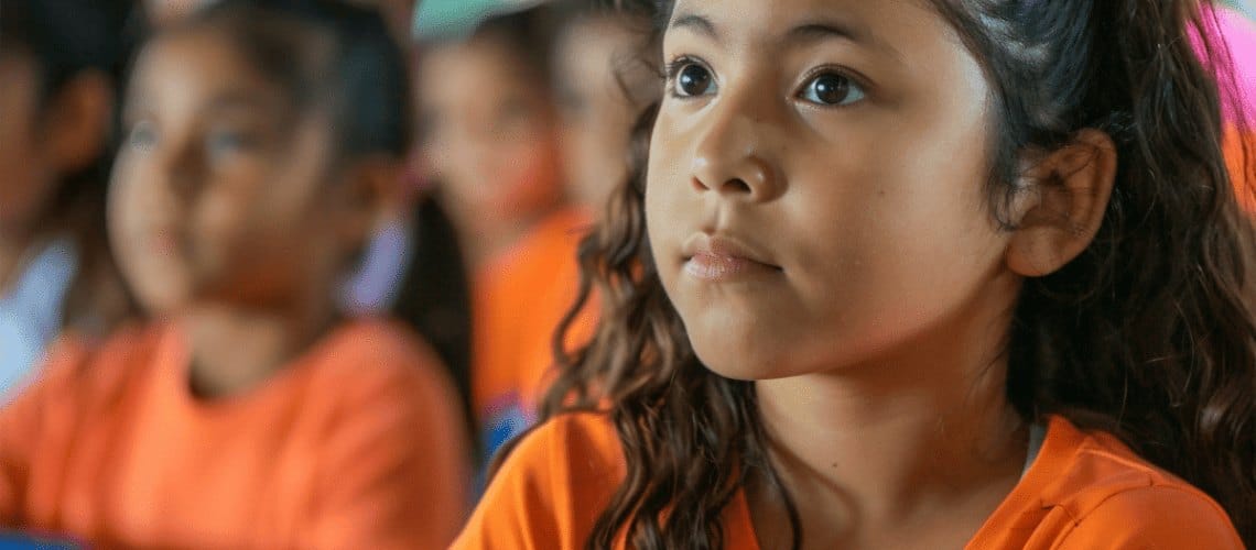 A Close-up of a Girl Sitting at a Lecture in her School in North America