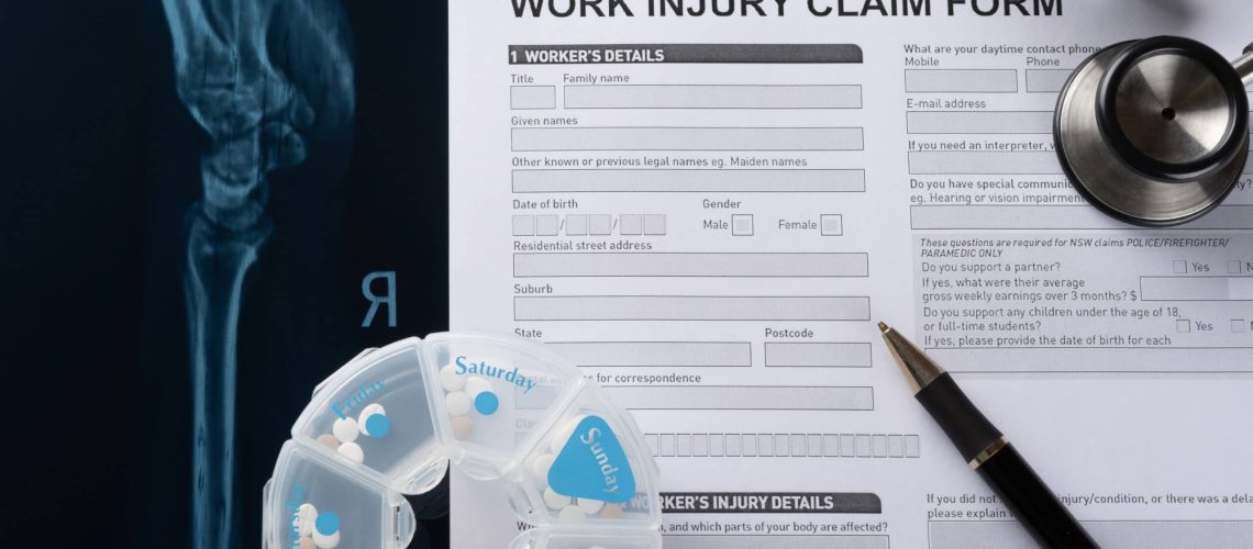 Work injury claim form with a pen, medicines & x-ray report